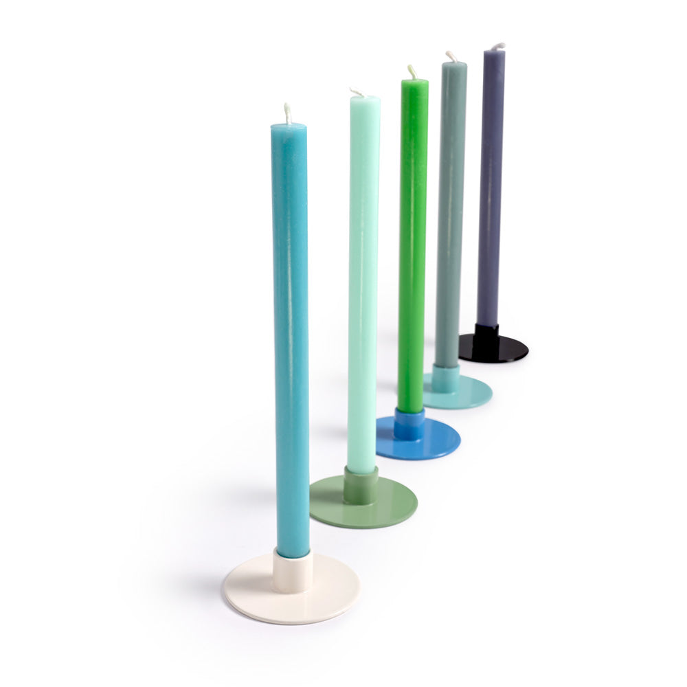 Set of colorful candles in stands on a white background