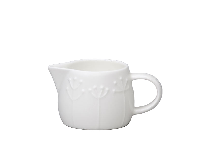 White ceramic pitcher on a gray background