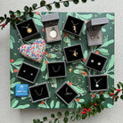 Jewelry set with various pieces displayed on a decorative green background with foliage.