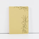 Yellow notebook with olive branch design on a white background