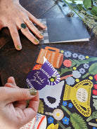 Colorful card with a dog illustration and text on a wooden surface.