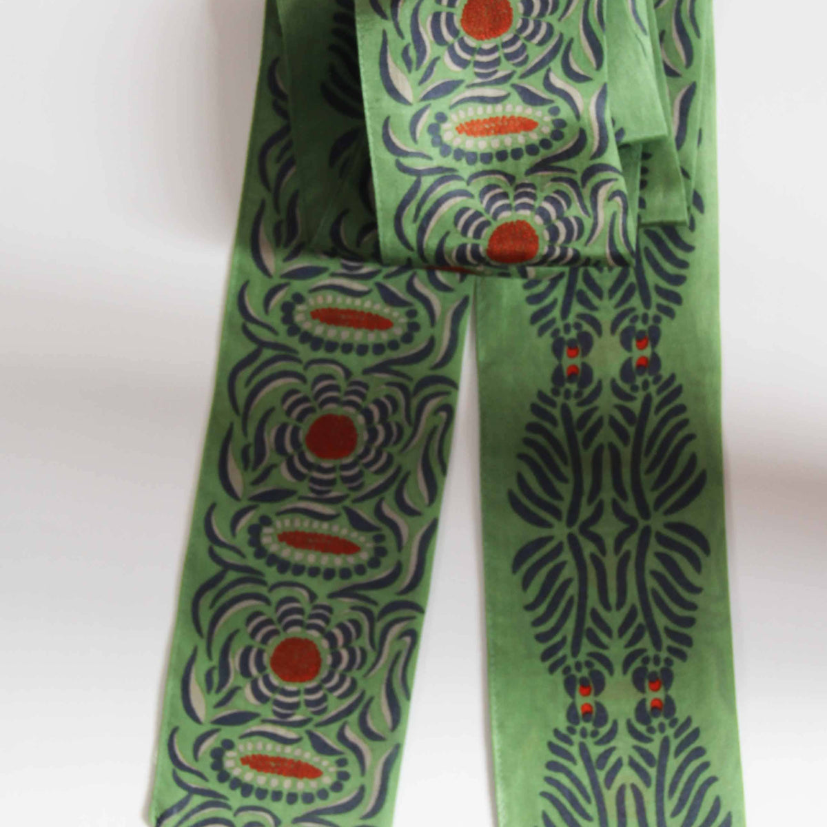 Green patterned scarf on a white background