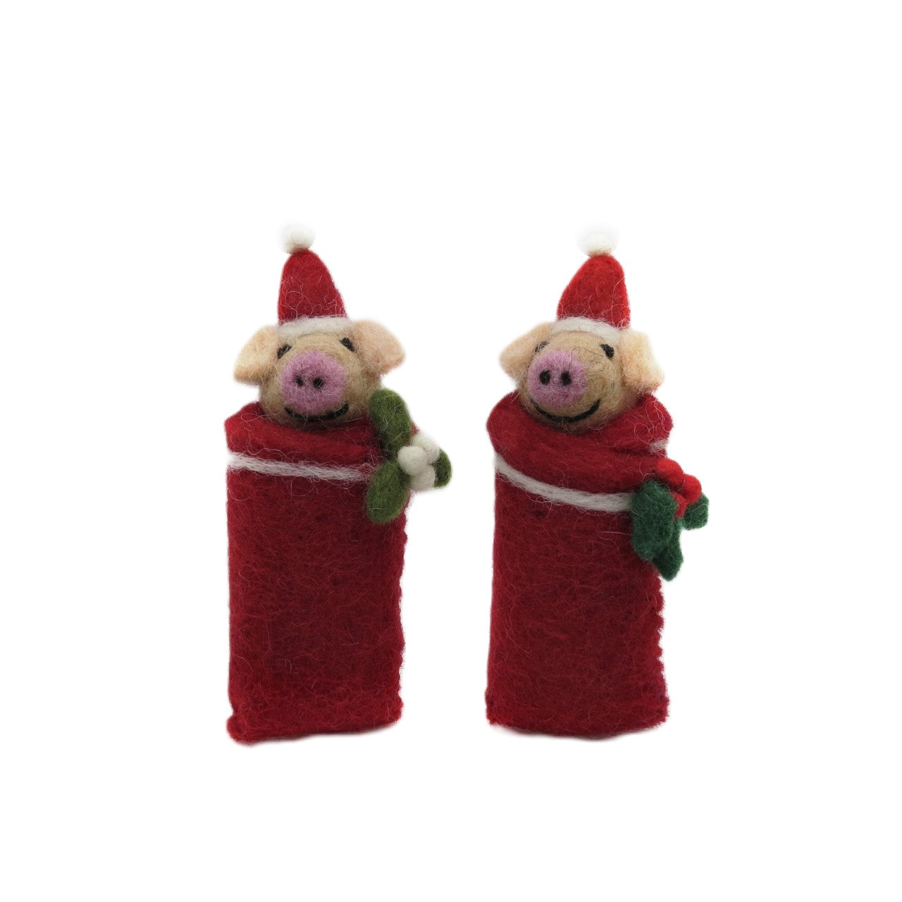 Two handmade felt piglet decorations for Christmas, each wearing a Santa hat and holding a small green branch.