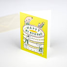 Birthday card with illustration of a cake and people around it on a yellow background