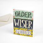 Card with text 'Older, Wiser, Smellier' on a white background