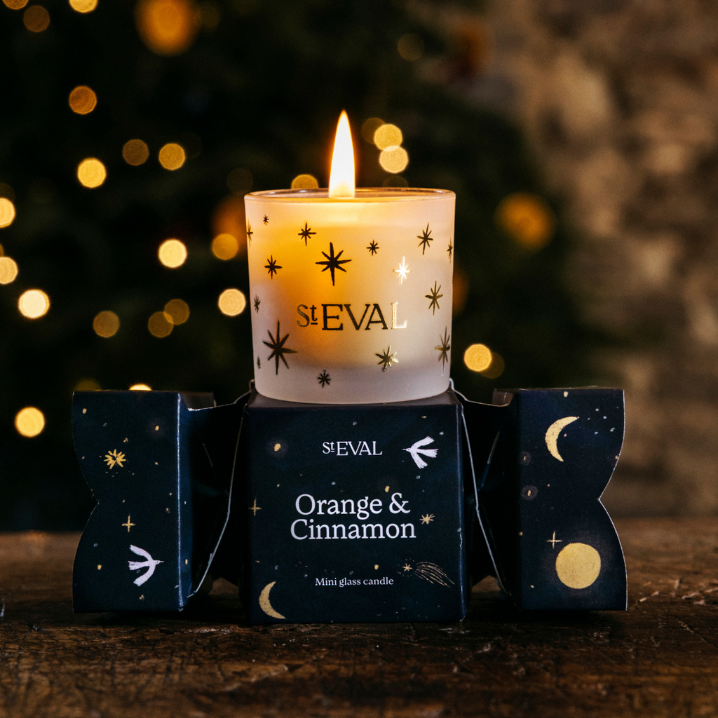 ST EVAL candle with packaging against a blurred festive background