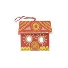 Decorative red birdhouse with yellow and white patterns on a white background