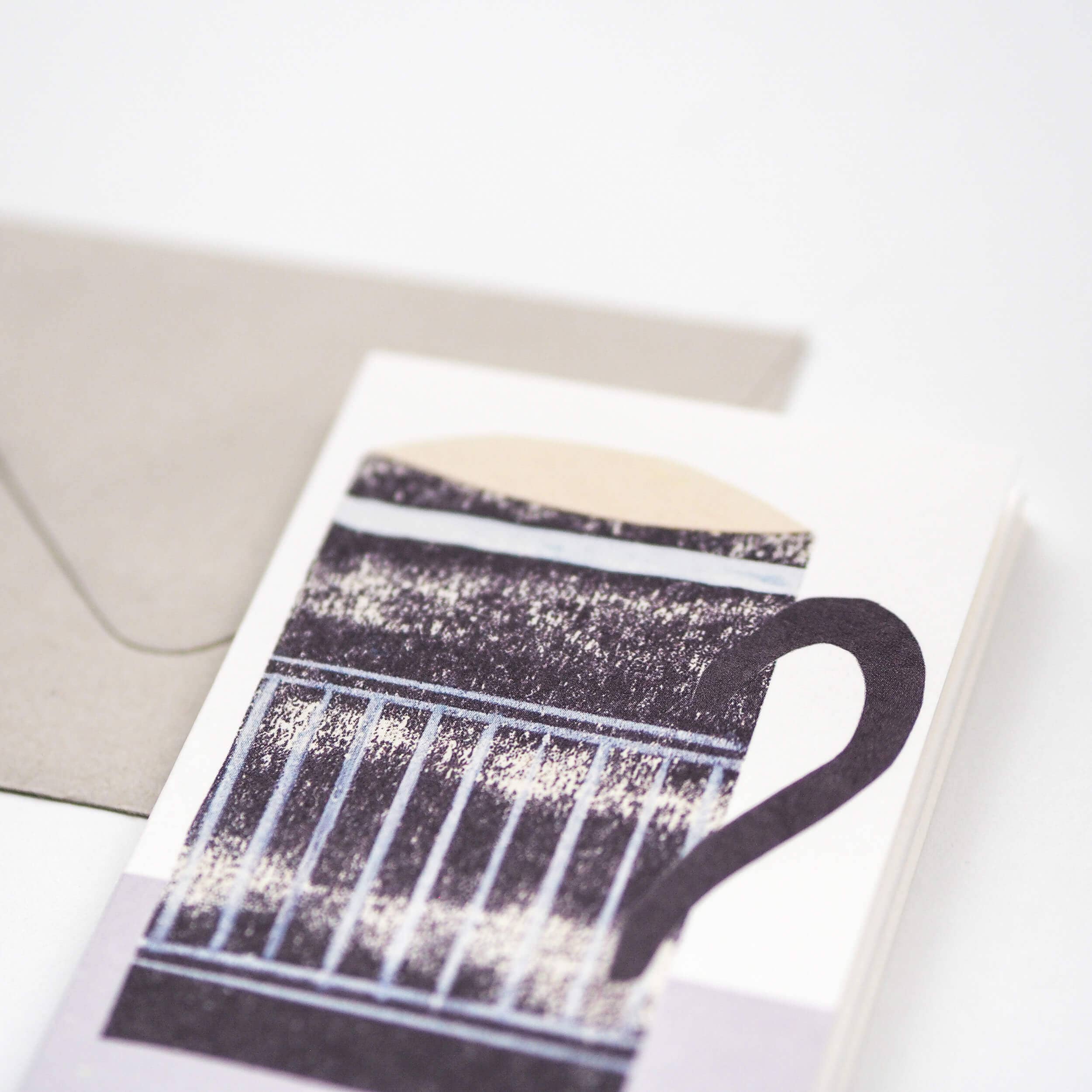 Card with a black and white illustration of a coffee cup on a white background