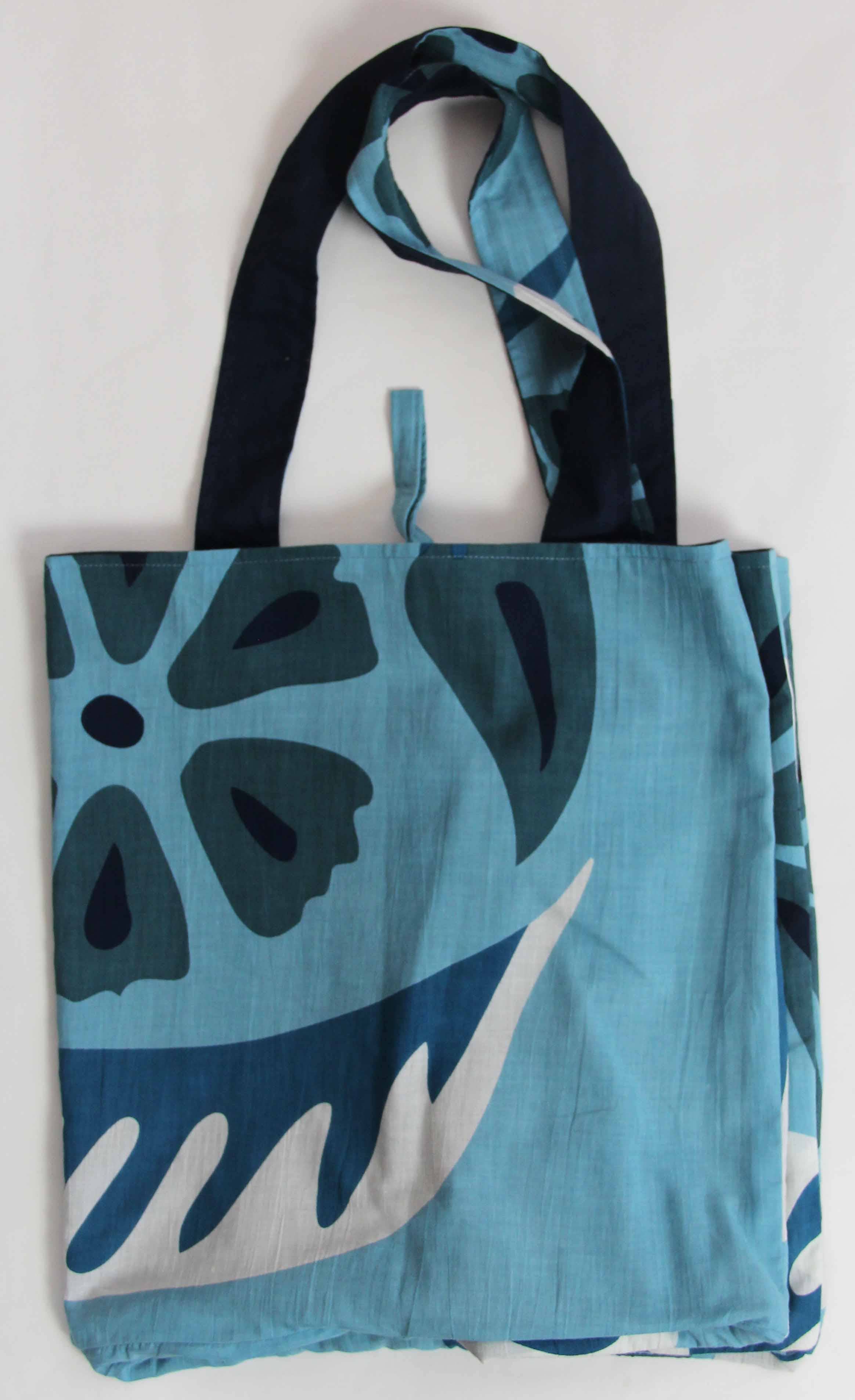 Tote bag with blue and black floral pattern on a white background