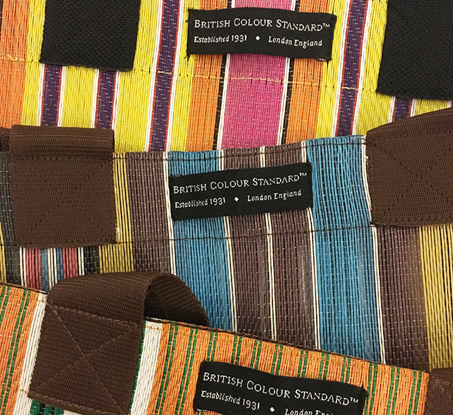 Reusable shopper with webbing handles, magnetic fastening and British Colour Standard label, in vibrant spring colours