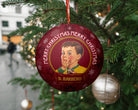 Decorative Christmas ornament with a vintage design of a boy and 'Merry Christmas' text, hanging on a tree.