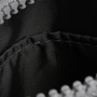 Close-up of black fabric with stitching detail