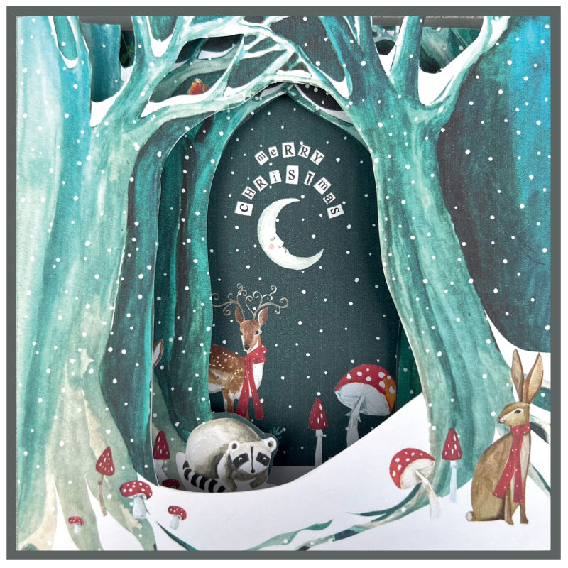 Winter forest scene with animals and 'Merry Christmas' text.