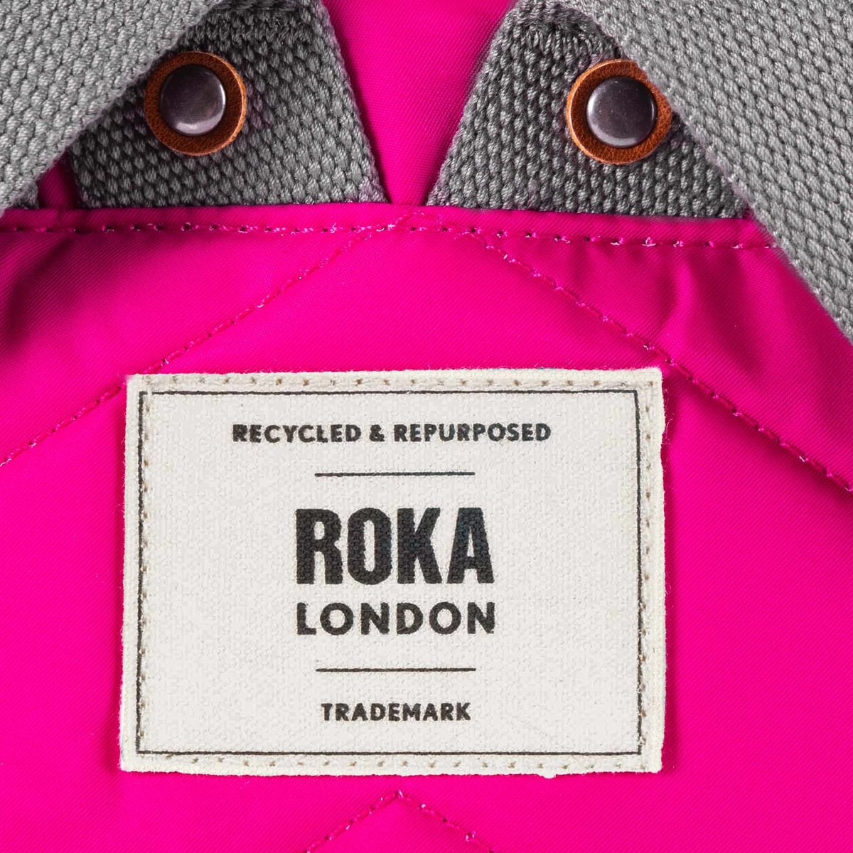 Close up image of a ROKA London label on a pink backpack