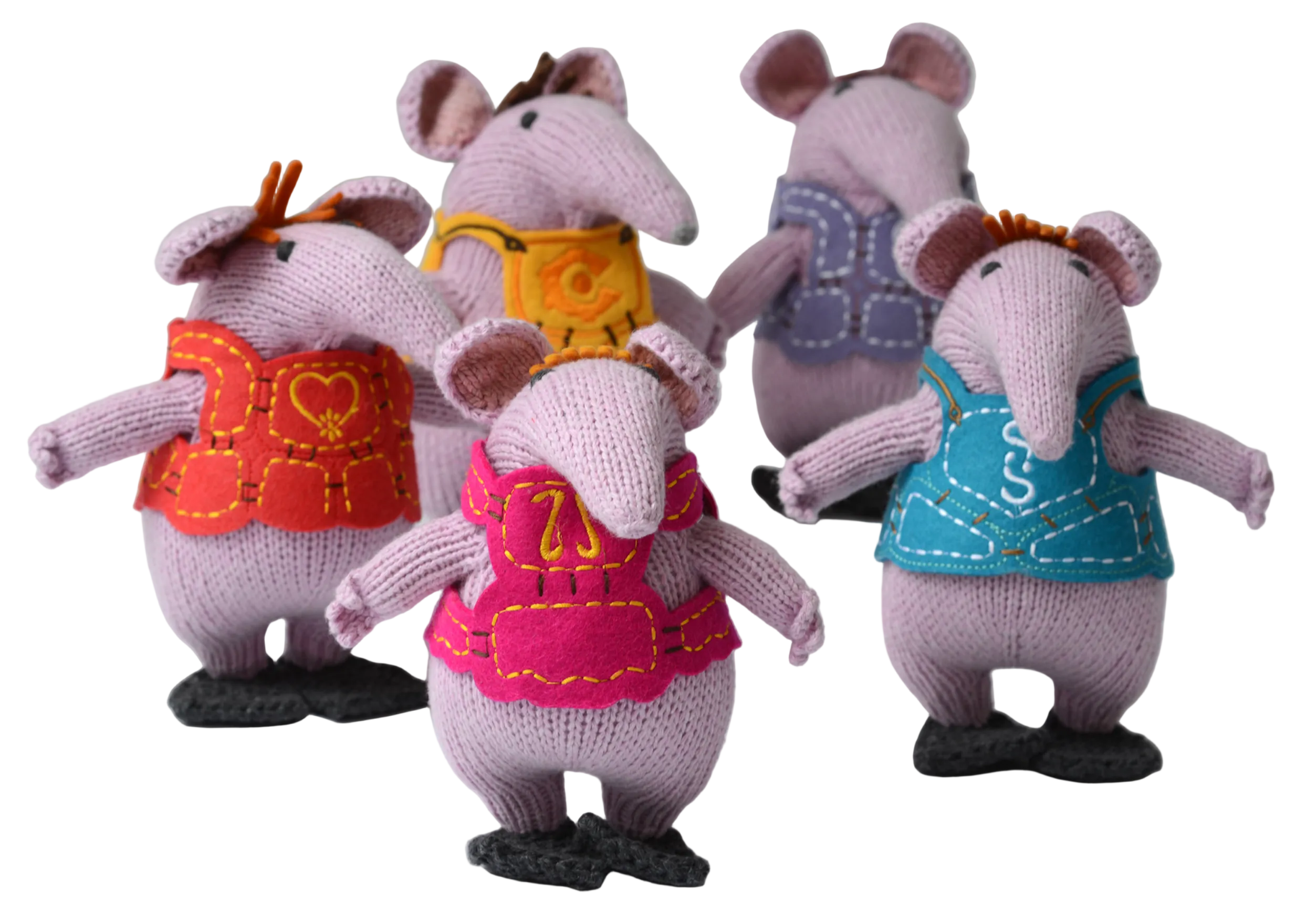Five knitted mouse plush toys standing side by side, each wearing a different coloured vest. The vests are orange-red, yellow, pink, and blue, and the mice are made of light purple-pink knit fabric.