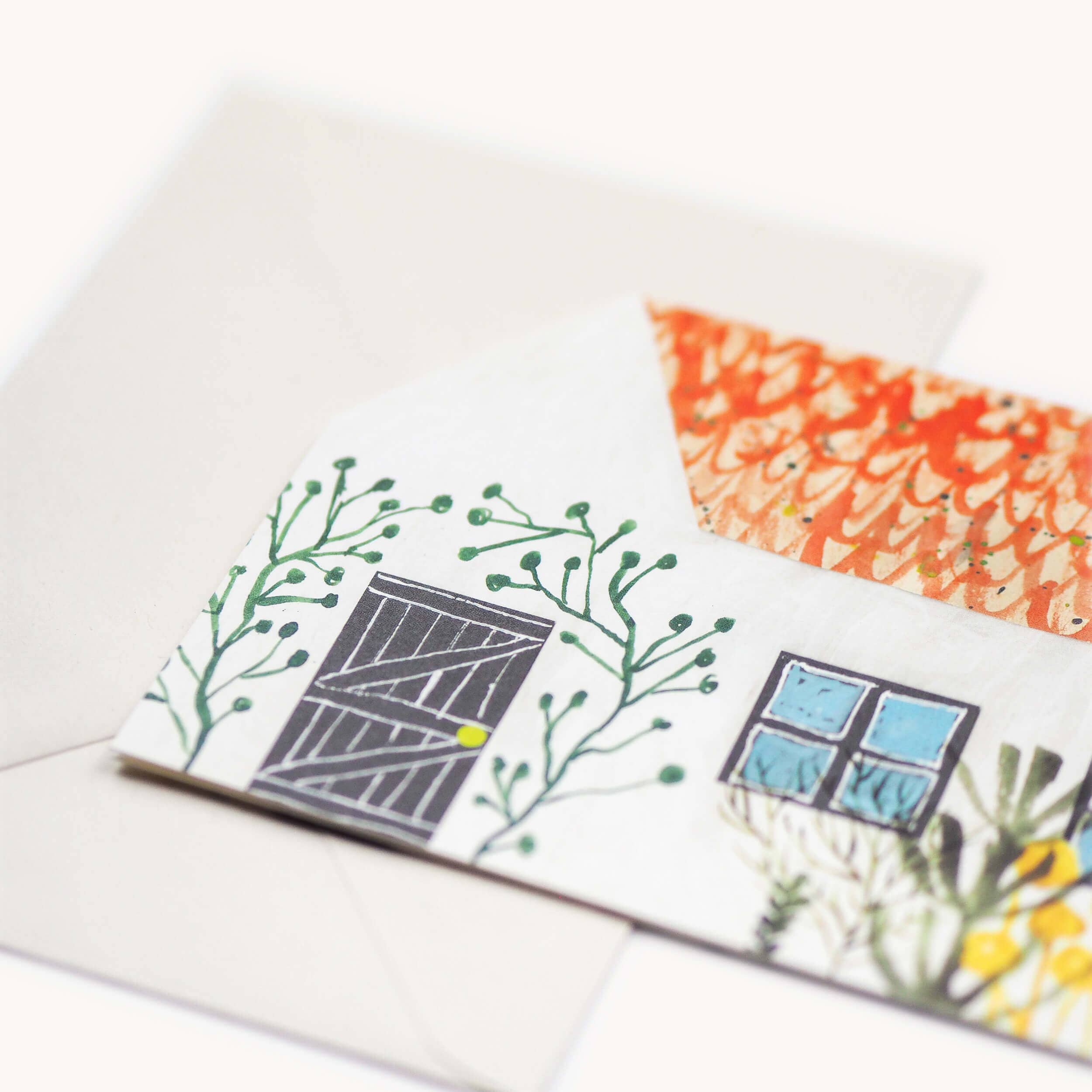 Close up shot of cottage themed greetings card on a white surface