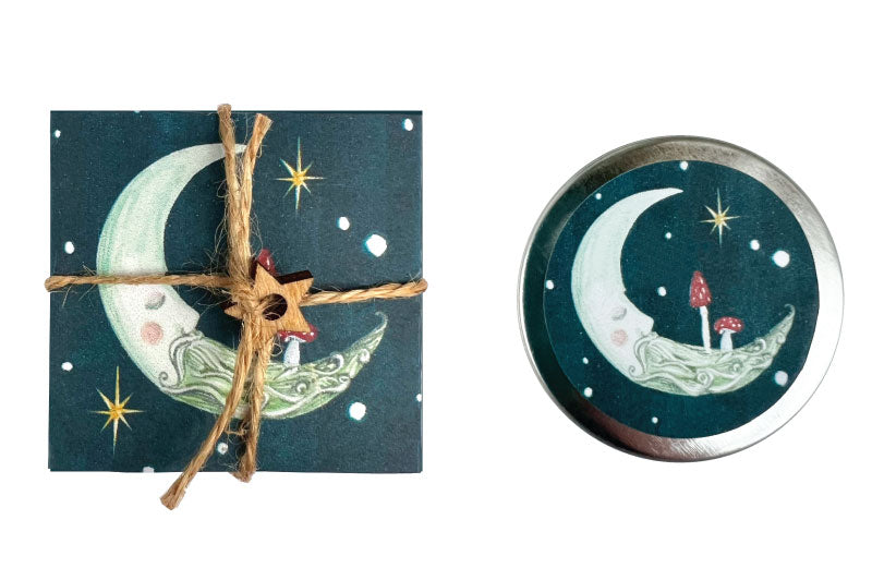 Decorative lipbalm with moon design on a blue background, tied with twine.