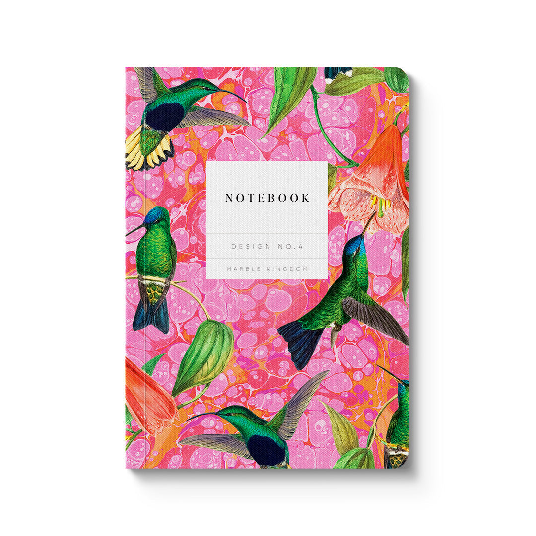 Notebook with a colorful design of hummingbirds and flowers on a pink background