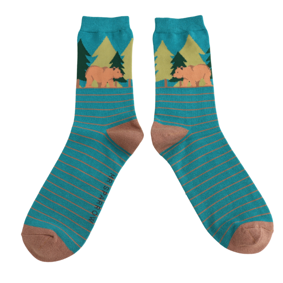 Teal socks with bear and tree design on a white background