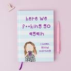 Notebook with a humorous illustration and text on a pink background