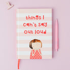 Notebook with a girl illustration and text on a pink background