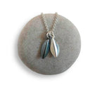 Silver seed pod necklace on a round stone