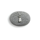 Silver sunflower pendant necklace on a gray stone with a white background