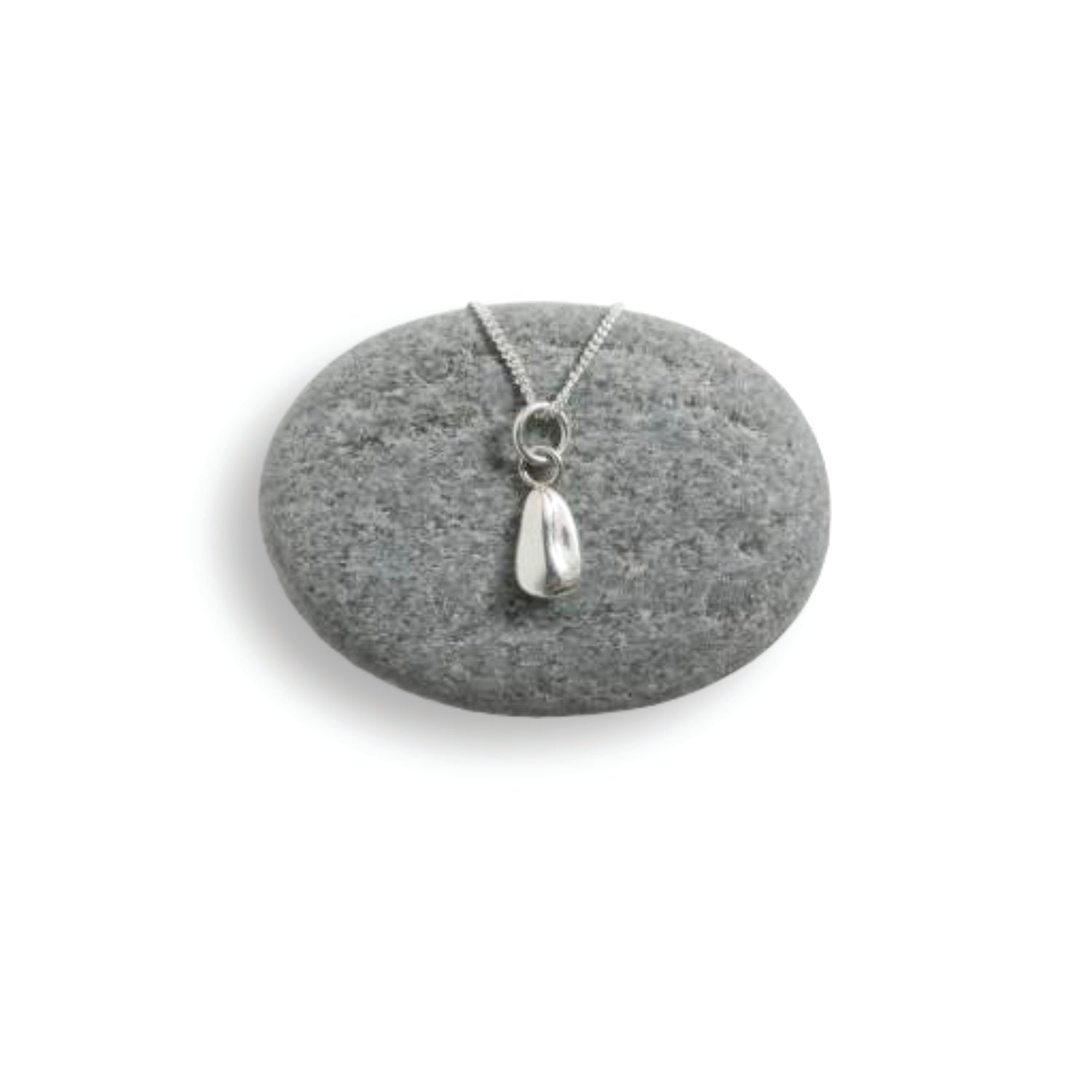Silver sunflower pendant necklace on a gray stone with a white background
