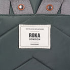 Gray fabric with a Roka London label on a gray background