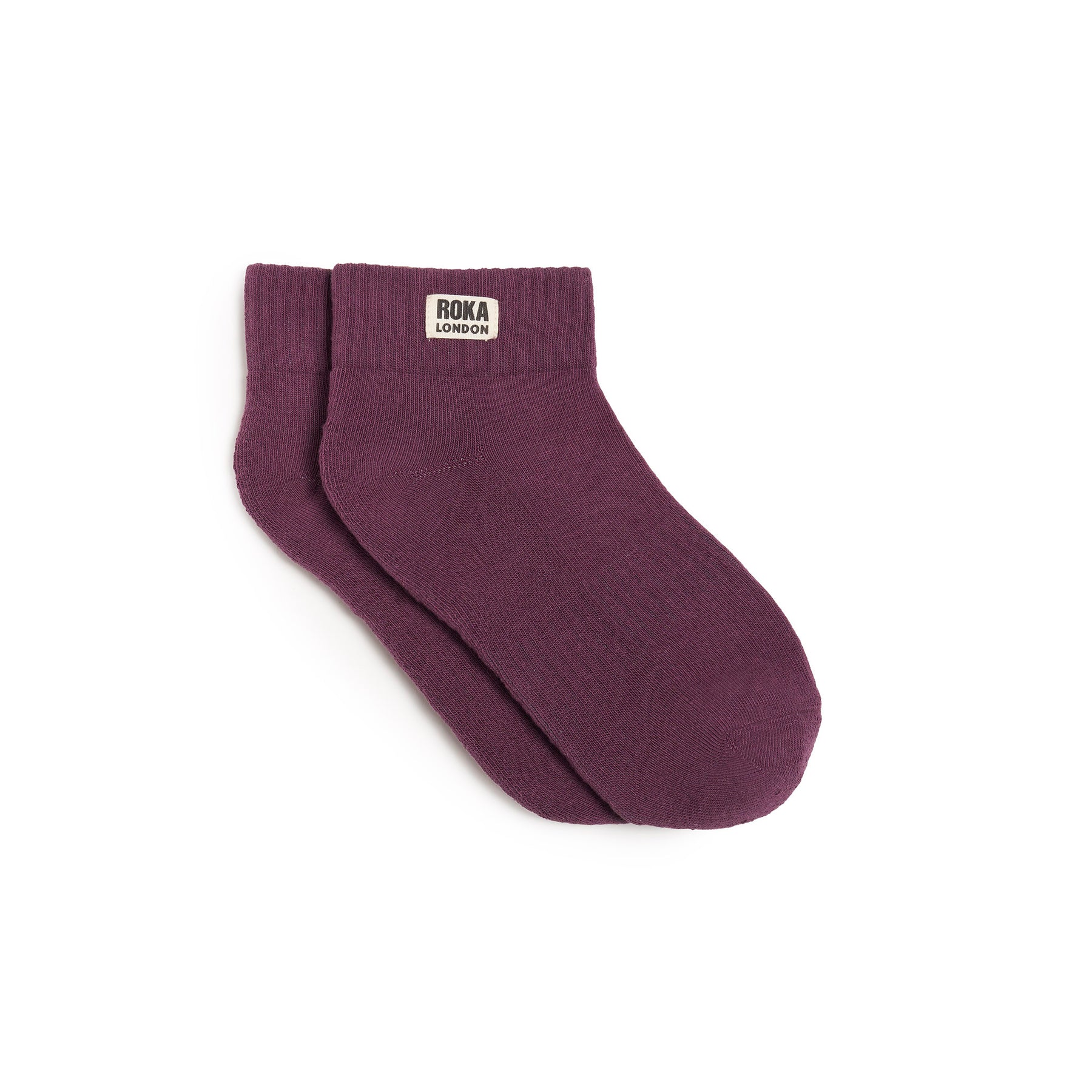 Maroon sock with 'ROKA' label on a white background