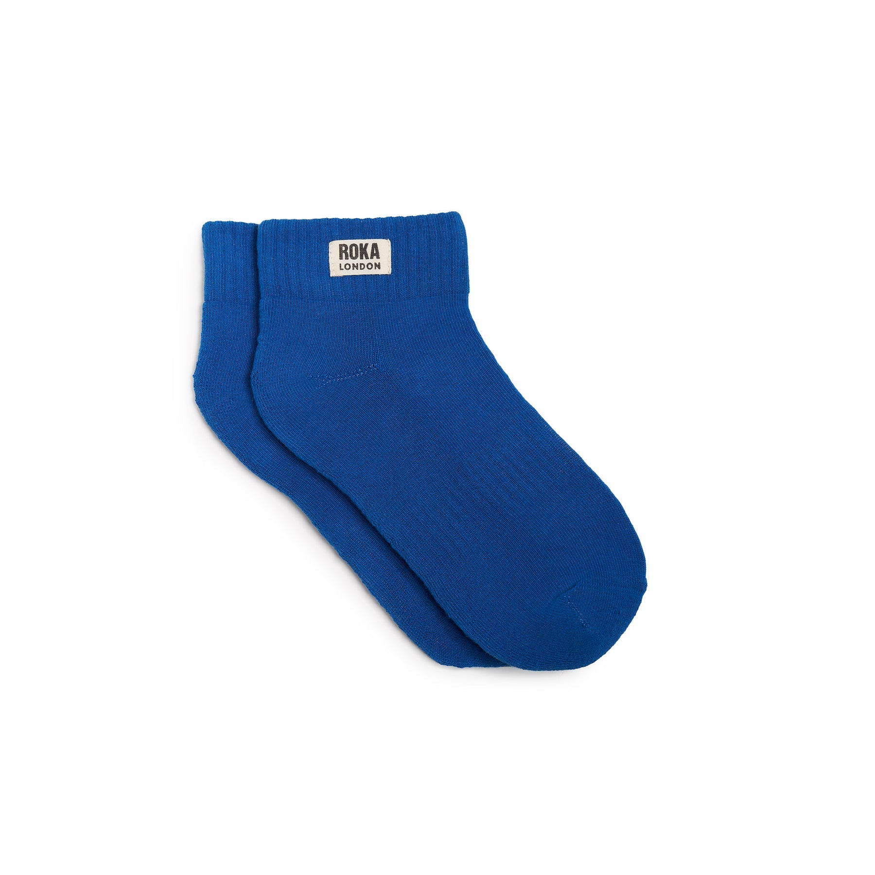 Pair of blue socks with a visible brand label on a white background