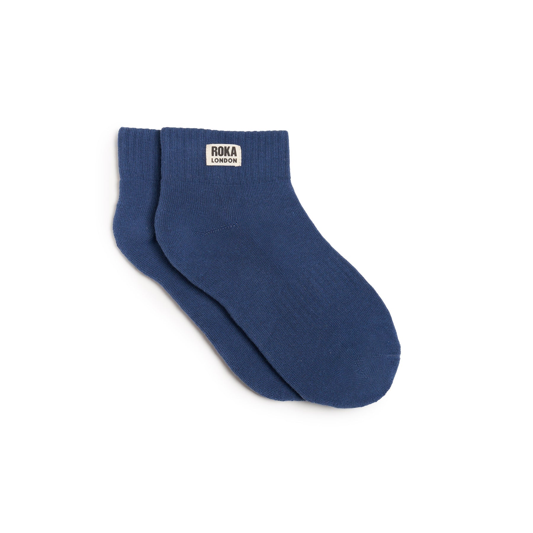 Blue sock with Roka London label on a white background