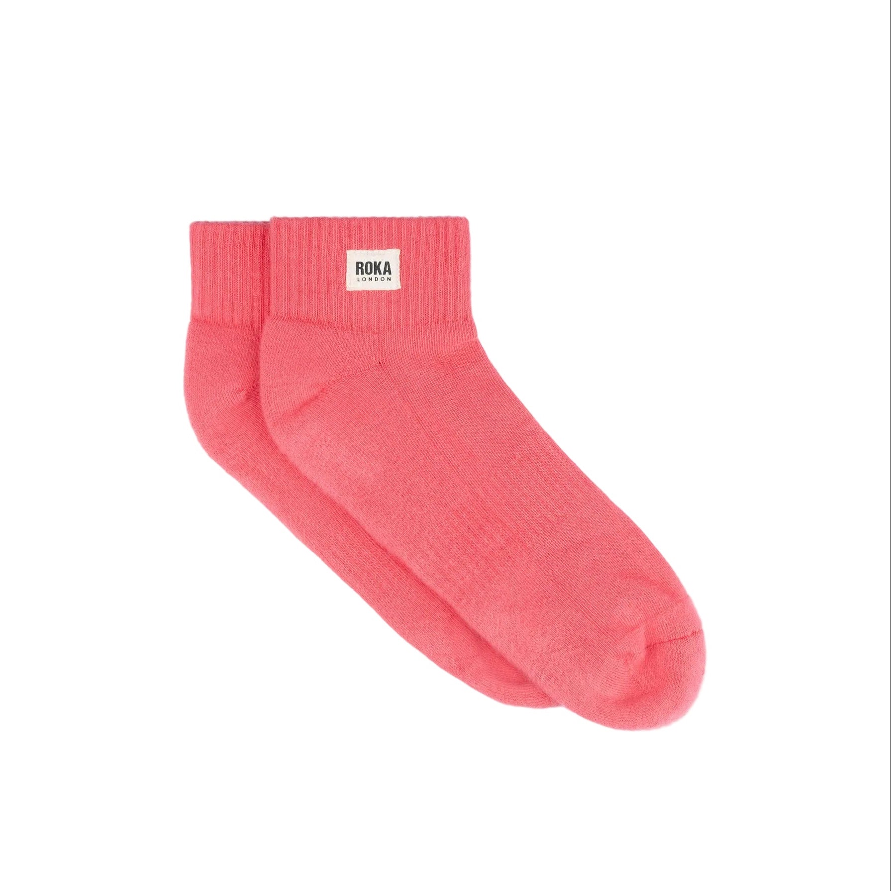 Pink sock with Roka label on a white background