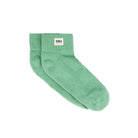 Green sock with a visible brand label on a white background