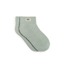 Pair of light green socks with 'ROKA LONDON' label on a white background