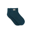 Pair of teal socks with a visible brand label on a white background