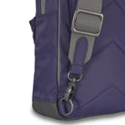 Close-up of a purple bag with gray strap and buckle on a white background