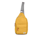 Yellow sling bag with a strap on a white background