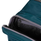 Close-up of a teal backpack with a zipper on a white background