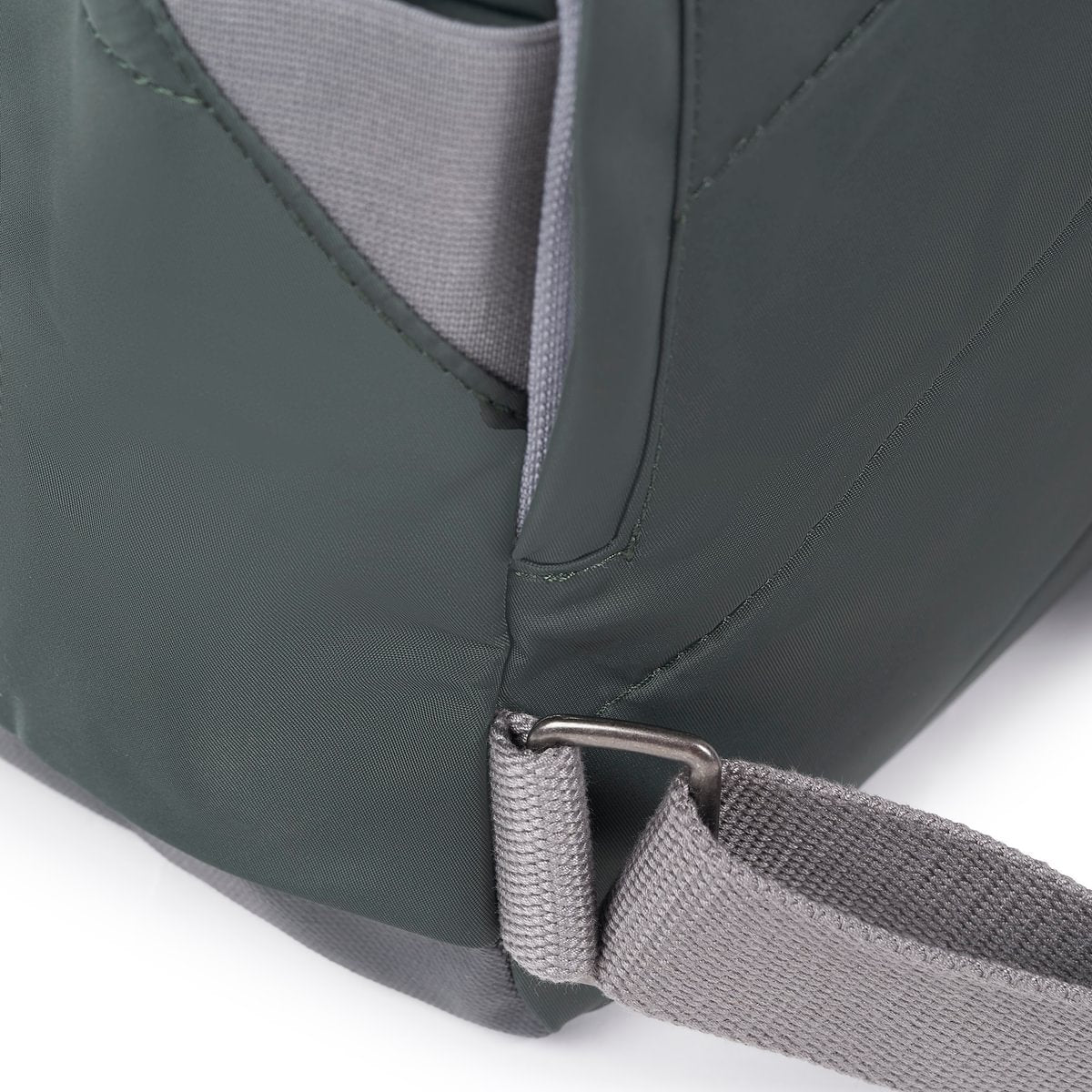 Close-up of a green bag with a strap on a white background