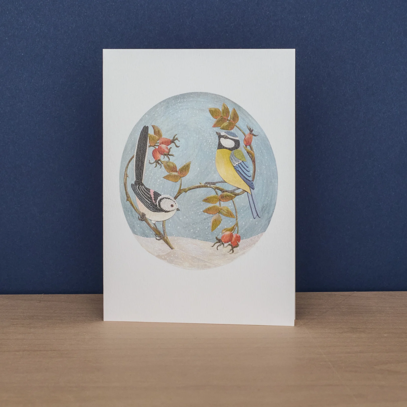 Card with bird illustration on a white background against a blue wall