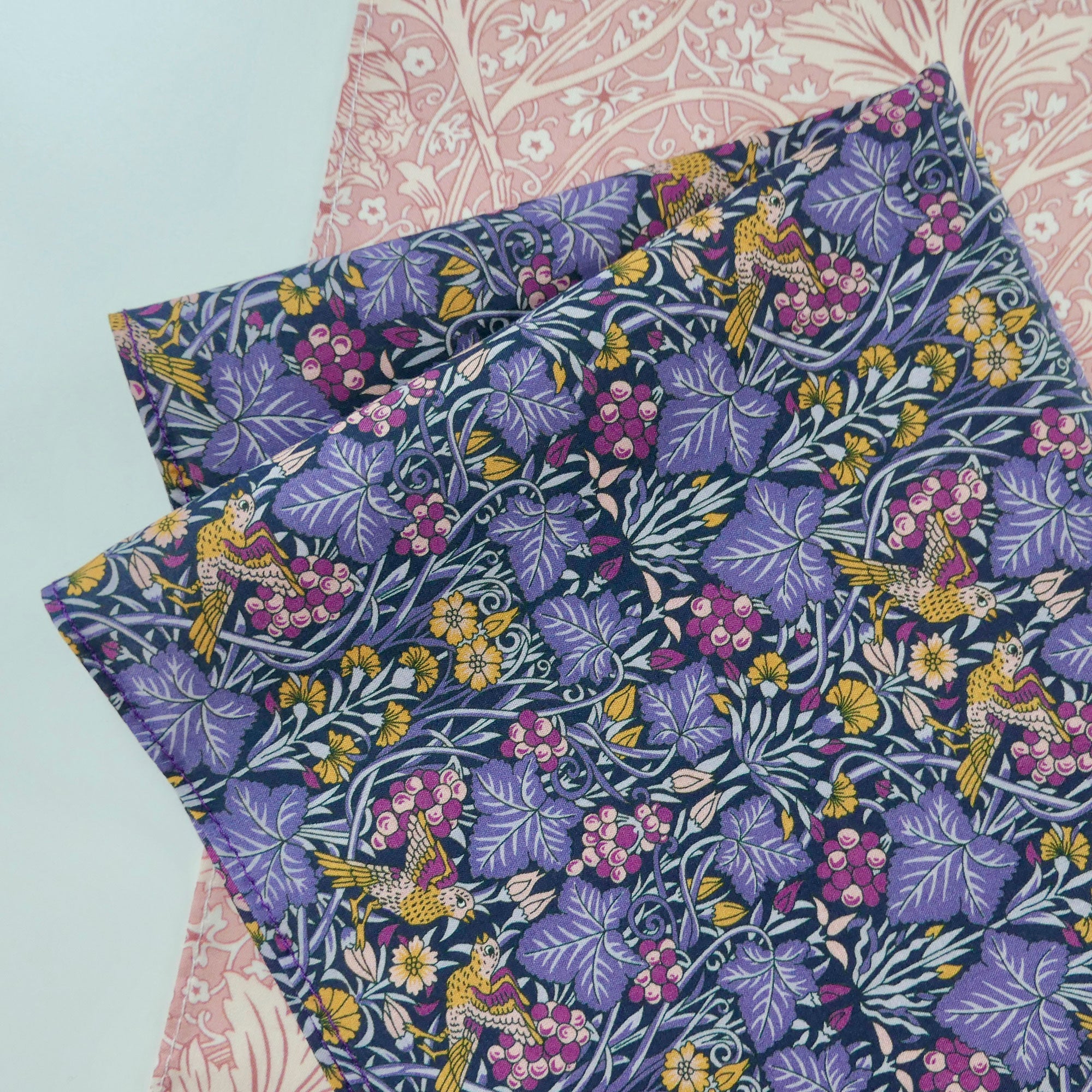 Floral fabric hankies with birds on a light blue background