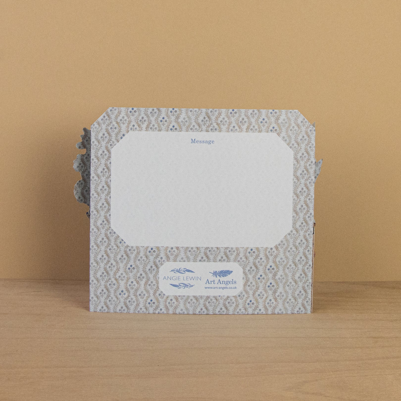 Decorative card with a patterned border on a wooden surface