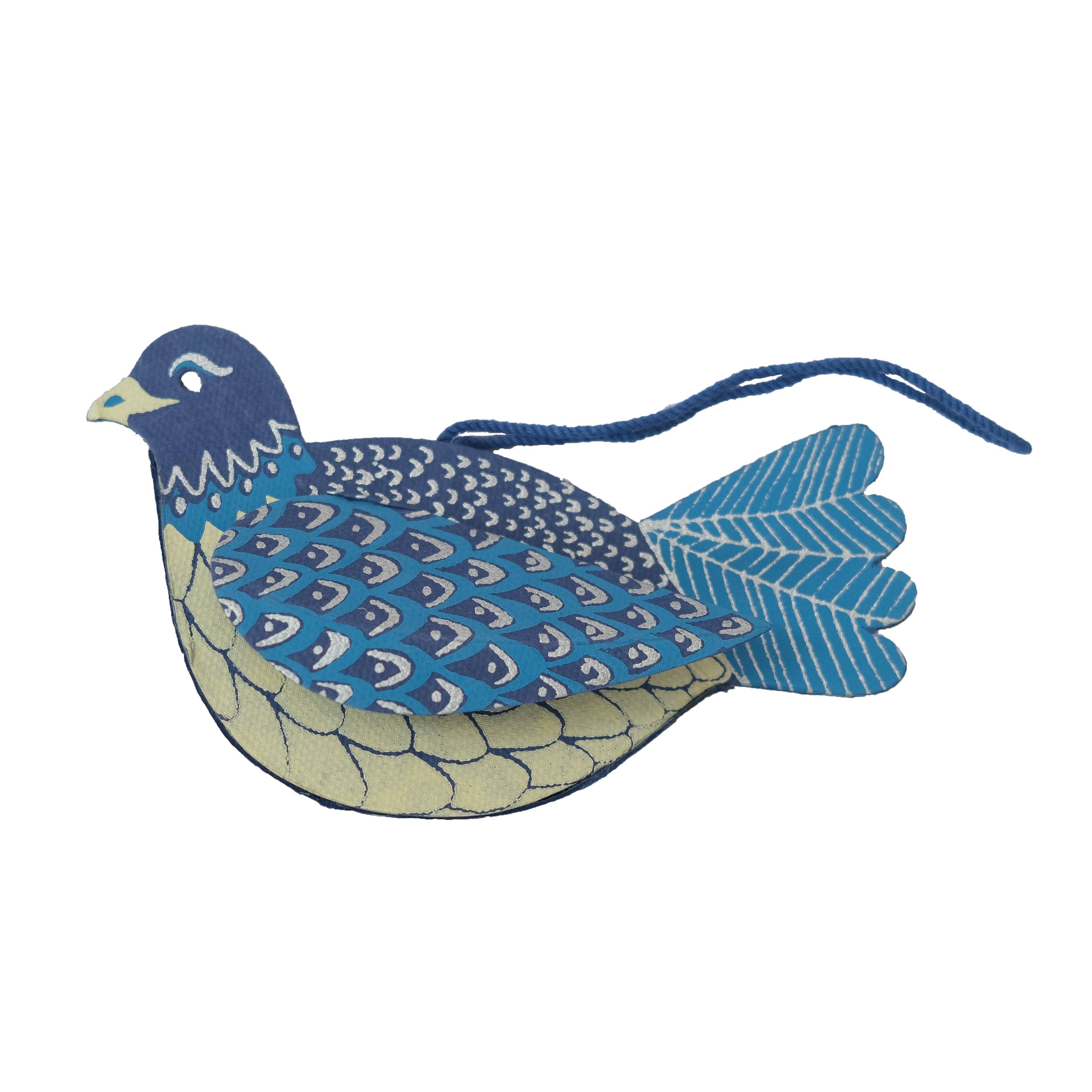 Decorative blue and beige bird ornament on a white background