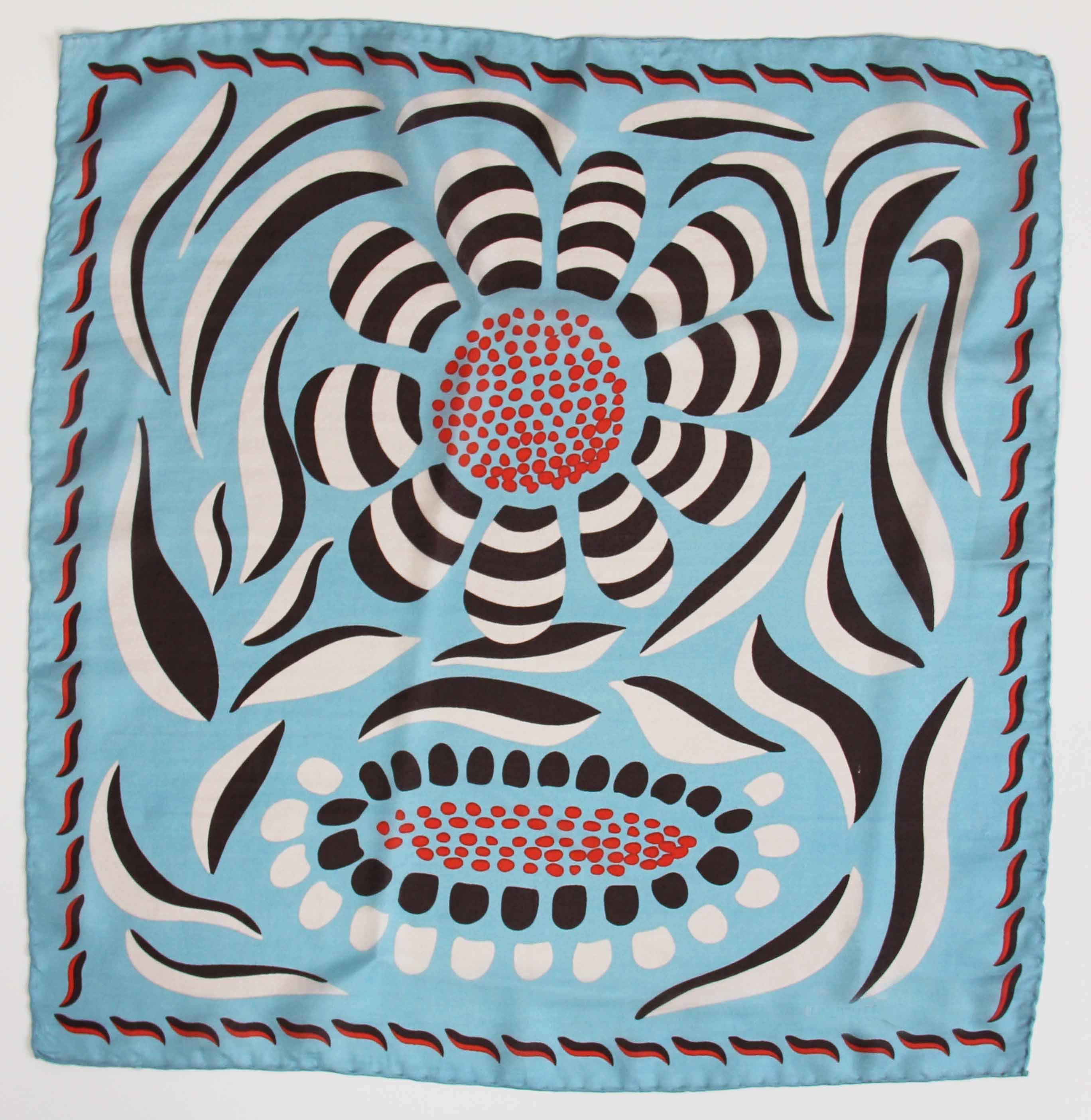 Decorative fabric square with a floral pattern on a light blue background