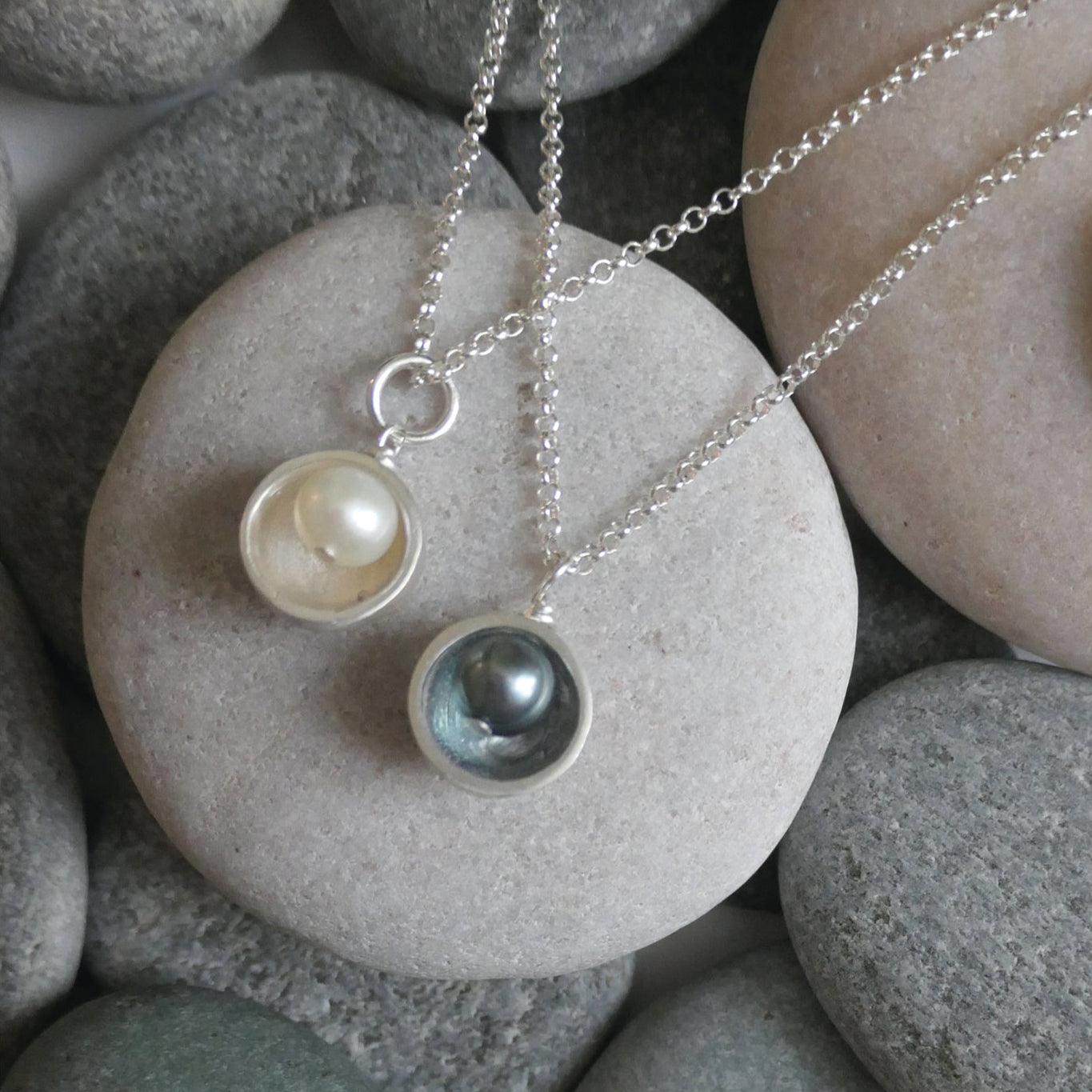 Necklace with pendant on pebbles