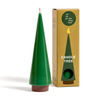 Green candle shaped like a tree next to its packaging box on a white background
