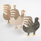 Three paper goose figures on a white background