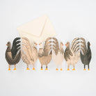 Set of stylized rooster illustrations with a letter on a light gray background
