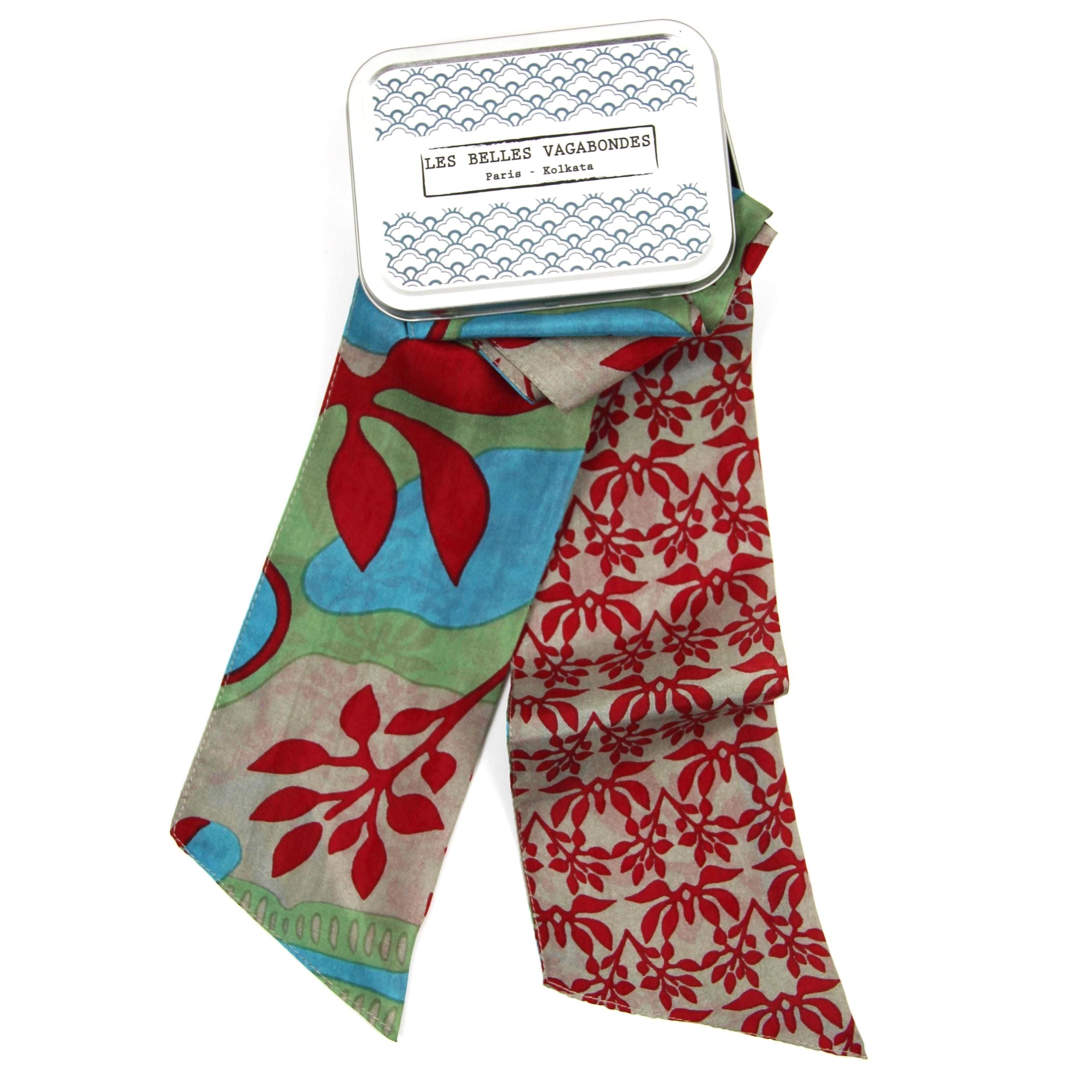 Colorful floral-patterned scarf with a brand label on a white background